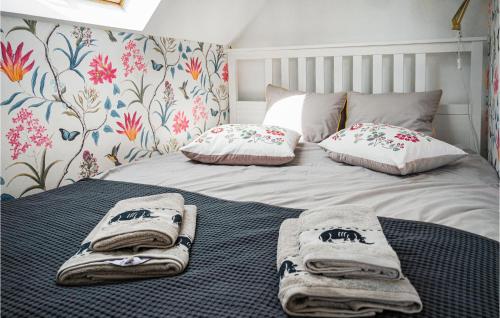 a bed with towels and pillows on top of it at Nice Home In Gniewino With Kitchen in Gniewino