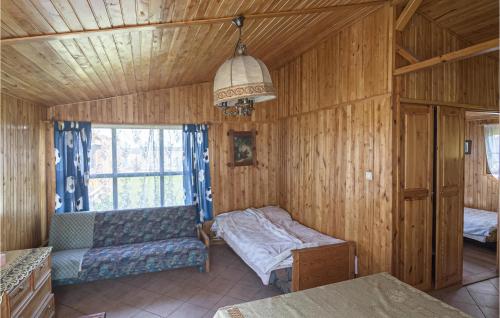 a room with a bed and a couch and a window at 1 Bedroom Stunning Home In Wilczeta in WilczÄ™ta