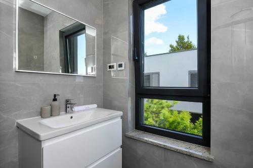 a bathroom with a sink and a window at Vila MI in Orebić