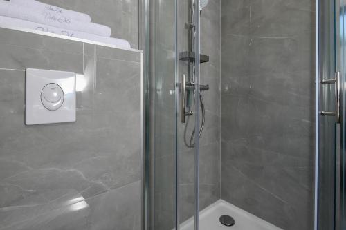 a bathroom with a shower with a glass door at Vila MI in Orebić