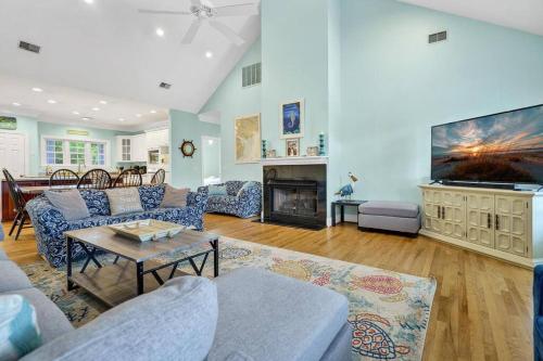 a living room with a couch and a fireplace at Pompano Pool House in Edisto Island