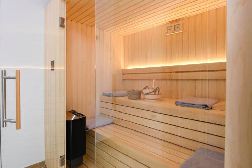 a sauna with wood paneling and a shelf with towels at Vila MI in Orebić