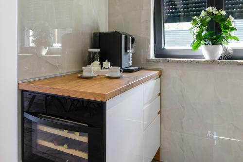 a kitchen with a counter top and a microwave at Vila MI in Orebić