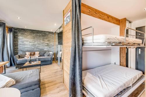 a room with two bunk beds and a couch at Résidence Pistes - Studio 4 rénové - pied des pistes MAE-4648 in Tignes