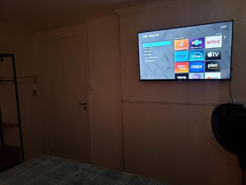 a flat screen tv hanging on a wall at Pousada Monte Gerizim in Sao Paulo
