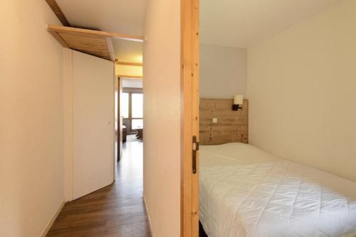 - une petite chambre avec un lit et une porte dans l'établissement Résidence Themis - 2 Pièces pour 5 Personnes 66, à Mâcot La Plagne