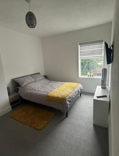 a bedroom with a bed and a window at Skegness Town Centre Apartment 2 in Skegness