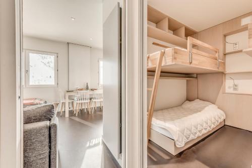 - une chambre avec des lits superposés et une salle à manger dans l'établissement Résidence Armaillis - Appartement rénové, vue lac MAE-6349, à Tignes