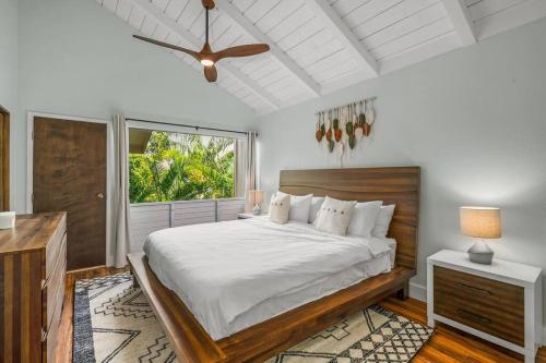 a bedroom with a large bed and a window at Contemporary 2-BR Condo AC & Scenic Views in PV in Princeville