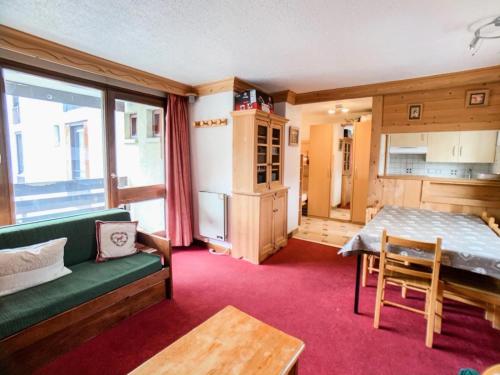 un salon avec un canapé vert et une table dans l'établissement Résidence Grand Tichot A - Appartement lumineux · Proche des pistes MAE-6737, à Tignes