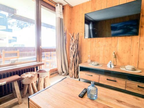 un salon avec une télévision sur un mur en bois dans l'établissement Résidence Pramecou - 2 pièces confort à proximité des commerces MAE-6783, à Tignes
