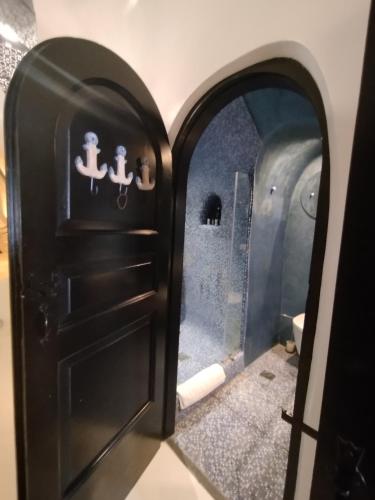 a door in a room with a bathroom at Villa Orpheus Santorini in Megalokhori