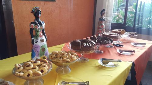 a table topped with bowls of food on a table at Pousada dos Veleiros in Nova Almeida