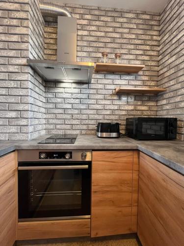 a kitchen with a stove and a microwave at Boris’s Guest Apartment in Chepelare