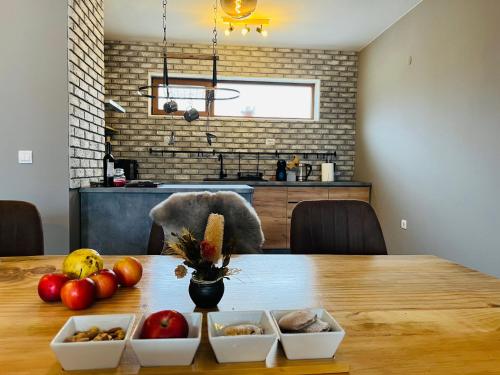 a table with bowls of fruits and vegetables on it at Boris’s Guest Apartment in Chepelare