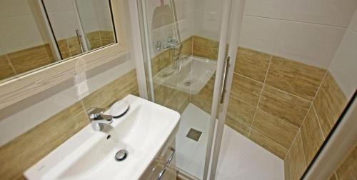 a white bathroom with a sink and a shower at Résidence Curling A - Par dessus les toits, vue Grande Motte MAE-1164 in Tignes