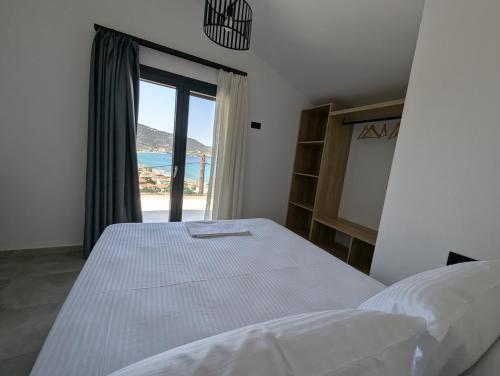 a bedroom with a bed and a large window at Villa Selini in Skala Potamias