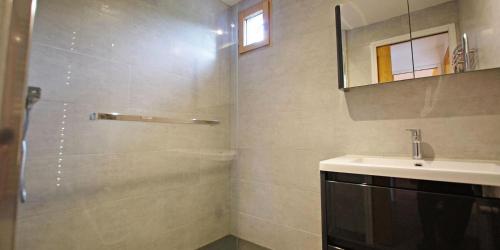 a bathroom with a shower and a sink and a mirror at Résidence Grand Tichot B - 4 pièces 80m2 - Au coeur du Val Claret MAE-2314 in Tignes