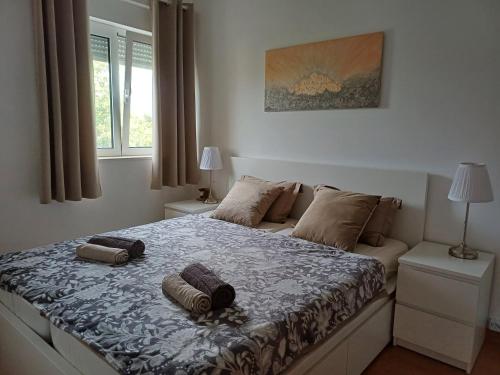 a bedroom with a bed with two pillows on it at Eco friendly apartment in Ližnjan