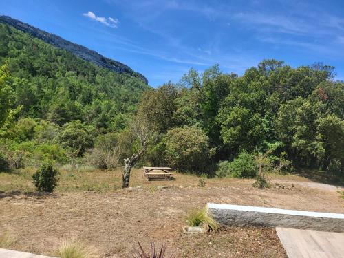a picnic table in a field with trees at Casa en plena Montaña in Prades