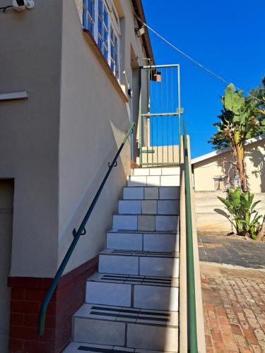 a set of stairs leading up to a building at PMB Backpackers Lodge in Pietermaritzburg