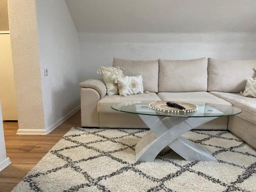 a living room with a couch and a glass table at Old town Suburb Apartment in Sarajevo