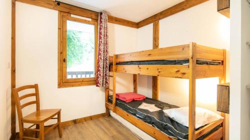 a room with two bunk beds and a chair at Le Chalet De Montchavin - Magnifique appartement rénové MAE-4234 in La Plagne Tarentaise