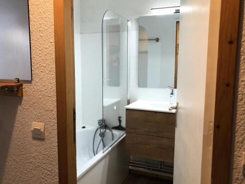 une salle de bain avec une baignoire, un lavabo et un miroir dans l'établissement Résidence Le Tetras Lyre - Au pied du télécabine bel appartement MAE-4494, à La Plagne Tarentaise