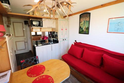 un salon avec un canapé rouge et une table dans l'établissement Résidence Palafour - Studette sur le front de neige MAE-7854, à Tignes