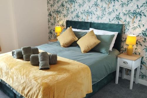 a bed with pillows on it in a bedroom at The Green Top flat with parking included amazing views and perfect location in Plymouth