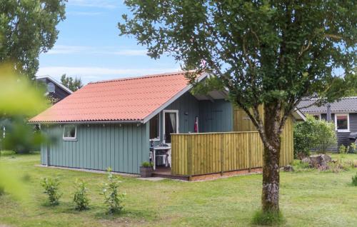 a green shed with a red roof and a fence at Nice Home In Hovborg With Wifi in Hovborg