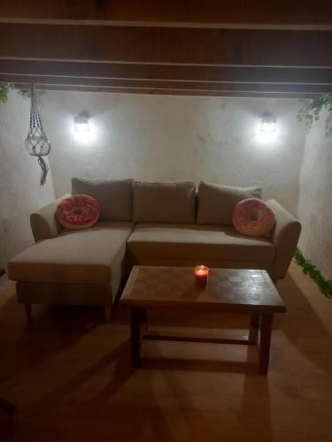 a living room with a couch and a coffee table at Appartement gourmand in Sisteron