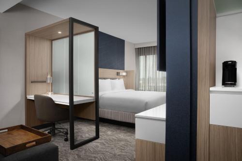 a hotel room with a bed and a desk and a mirror at Springhill Suites by Marriott Lexington Fritz Farm in Lexington