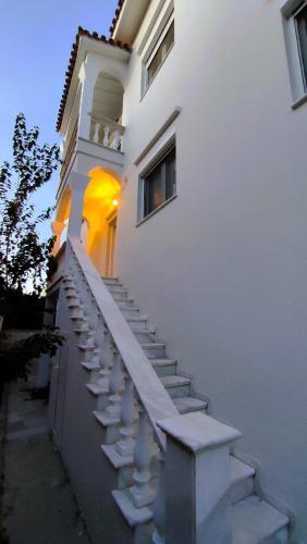 a stairway leading up to a white building at Medusa Myrina Luxury Apartments 1st Floor in Myrina