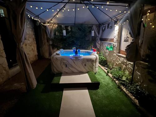 a jacuzzi tub in a tent with lights at Heraklia villa sea view pool & jacuzzi in Nea Iraklia