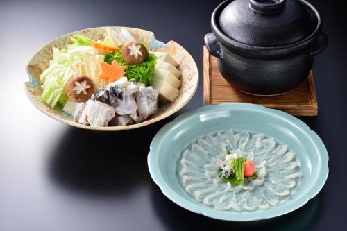 a bowl of food and a bowl of food on a table at Hakone Onsen Ryokan Yaeikan in Hakone