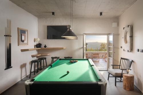a pool table in a living room with a pool at Villa Motovun in Motovun
