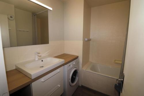 une salle de bain avec un lavabo et une machine à laver dans l'établissement Résidence Grande Balme Ii - Appartement rénové et lumineux MAE-2604, à Tignes