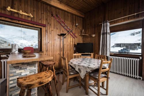 une salle à manger avec une table, des chaises et une télévision dans l'établissement Résidence Chaudes Almes - Appartement à l'entrée de Tignes le Lac MAE-2794, à Tignes