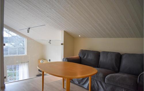 a living room with a couch and a table at Beautiful Home In Ronneby With Sauna in Ronneby