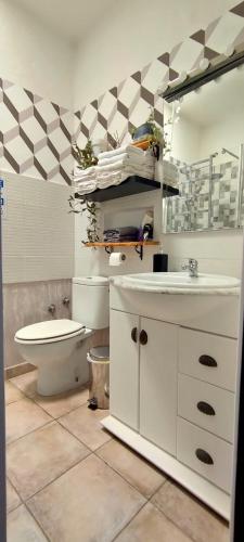 a bathroom with a sink and a toilet in it at El retiro azul in Gáldar