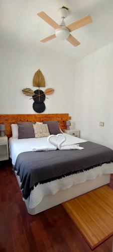 a bedroom with a bed with a ceiling fan at El retiro azul in Gáldar