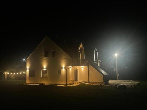 a church lit up at night with a street light at Villa Villekulla VV in Kolašin