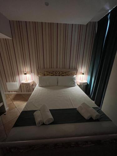 a bedroom with a bed with two towels on it at Residenza Catullo in Verona
