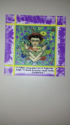 a painting of a woman in a window at Casa 24 Puerto Iguazu in Puerto Iguazú