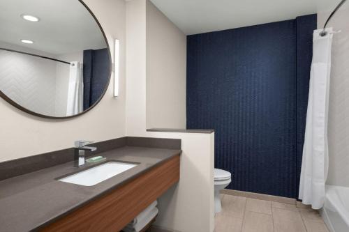 a bathroom with a sink and a mirror at Fairfield by Marriott Inn & Suites Victorville in Victorville