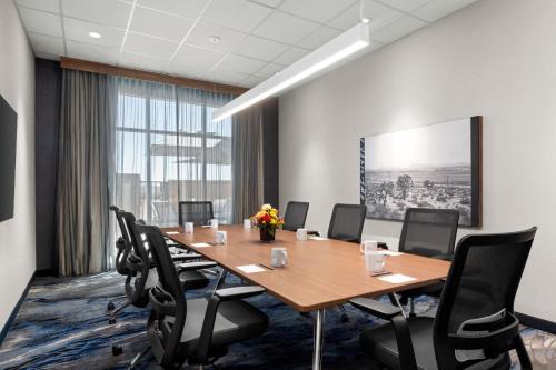 a conference room with a wooden table and chairs at Fairfield by Marriott Inn & Suites Victorville in Victorville