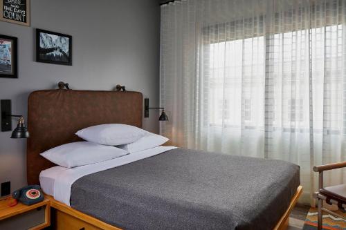 a bedroom with a bed and a large window at Moxy Chattanooga Downtown in Chattanooga