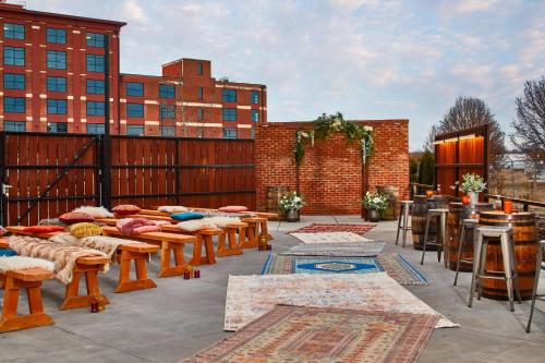 a patio with tables and chairs and a bar at Moxy Chattanooga Downtown in Chattanooga