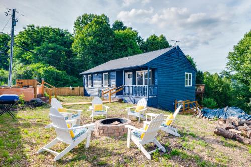 a group of chairs sitting in front of a blue house at The Getaway Lodge in the Blue Ridge Mountains near Roanoke & Bedford in Troutville
